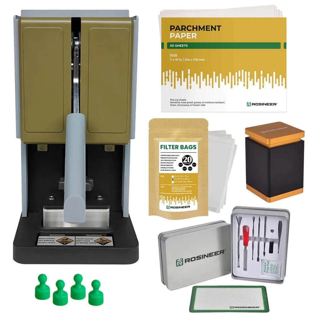 Rosin press with parchment paper, filter bags, dab tools, and green pegs.