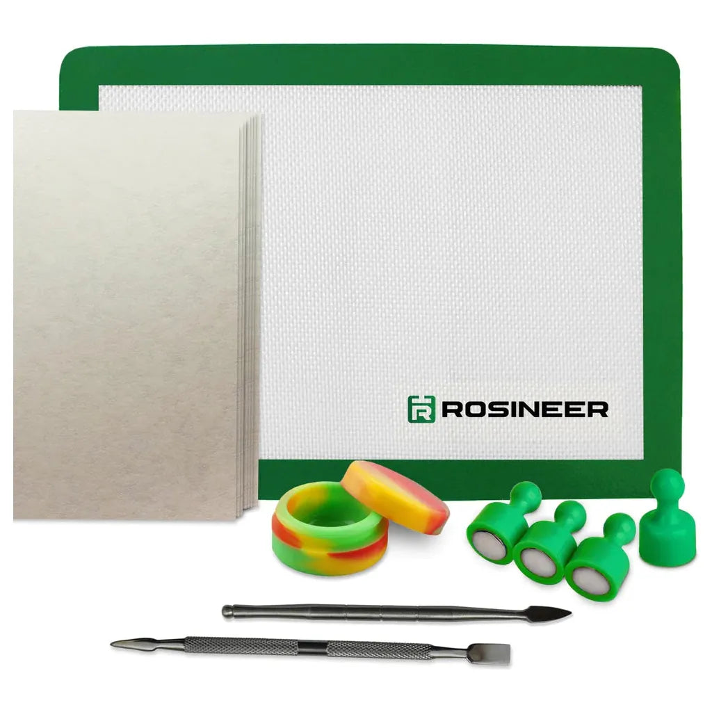 Rosineer rosin press starter kit: green silicone mat, dab tools, sticky dab jars, and parchment paper.